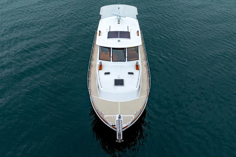 Slide: The Image of 2014 Grand Banks 46 Eastbay SX yacht on calm water, aerial view. - 7