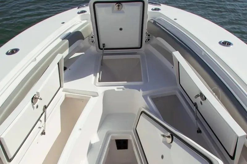 Slide: The Image of The image shows the bow of a Regulator 25 boat with multiple open storage compartments. - 3