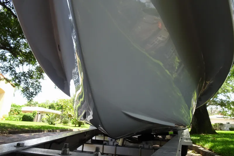 Slide: The Image of 2024 Xplor X18 Delta D18 boat hull on trailer, reflecting greenery. - 10