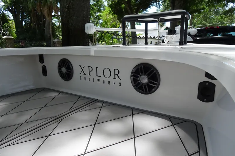 Slide: The Image of 2024 Xplor X18 Delta D18 boat interior with speakers and logo. - 13