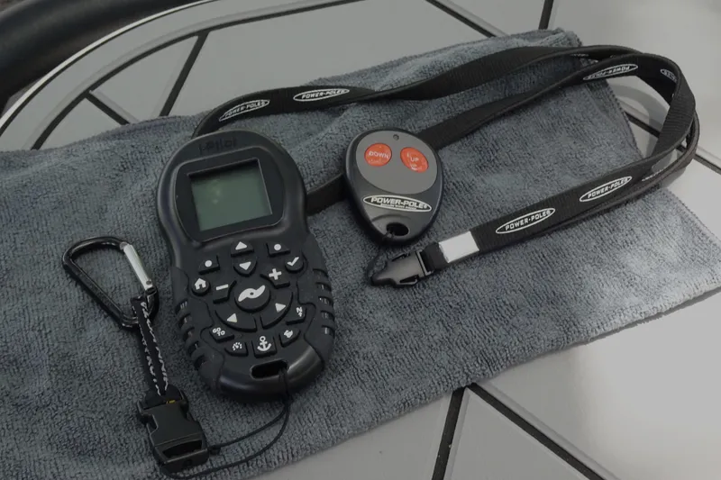Slide: The Image of Remote controls on a towel, featuring Xplor X18 Delta D18, 2024 model. - 18