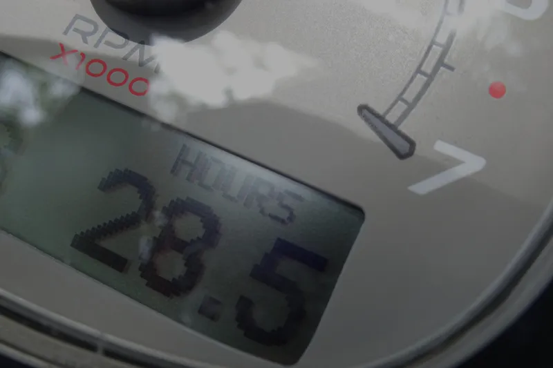Slide: The Image of Close-up of Xplor X18 Delta D18 tachometer displaying 28.5 hours. - 21