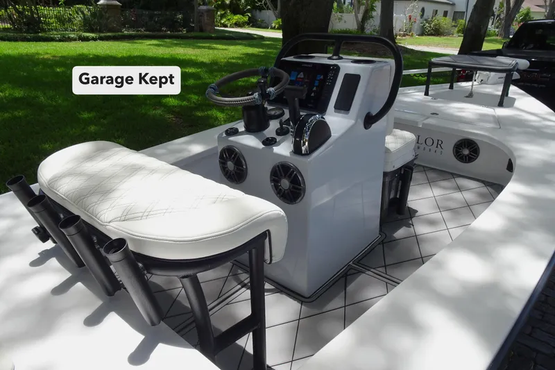 Slide: The Image of 2024 Xplor X18 Delta D18 boat interior with modern console, labeled "Garage Kept." - 6