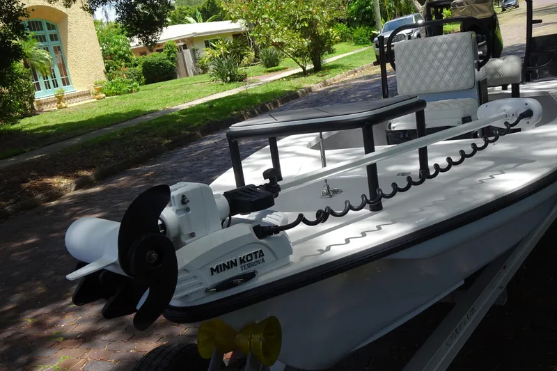 Slide: The Image of 2024 Xplor X18 Delta D18 boat with Minn Kota Terrova motor on a sunny street. - 7