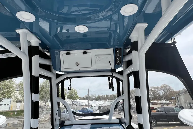 Slide: The Image of Interior view of 2026 Sea Pro 225FLX Sandbar boat with blue ceiling and white accents. - 10