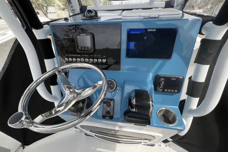 Slide: The Image of 2026 Sea Pro 225FLX Sandbar boat dashboard with steering wheel and navigation controls. - 11