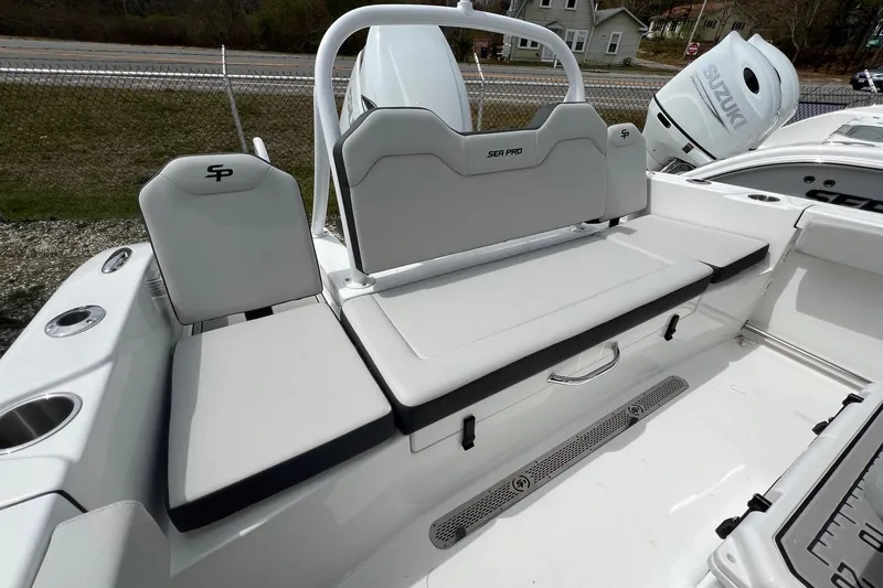 Slide: The Image of 2026 Sea Pro 225FLX Sandbar boat interior with white seating and Suzuki engine. - 12