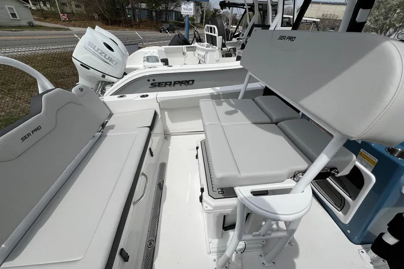 Slide: The Image of 2026 Sea Pro 225FLX Sandbar boat interior with seating and Suzuki engine. - 13