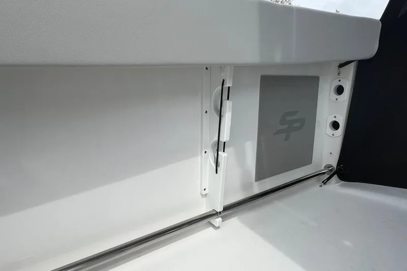 Slide: The Image of 2026 Sea Pro 225FLX Sandbar boat interior detail with logo and storage compartment. - 16