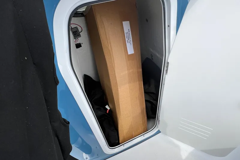 Slide: The Image of Storage compartment of 2026 Sea Pro 225FLX Sandbar boat with cardboard box inside. - 19