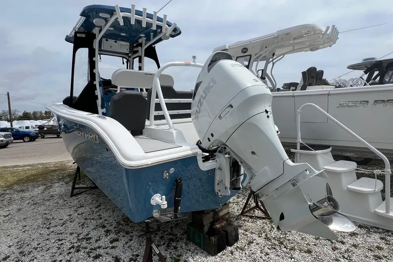 Slide: The Image of 2026 Sea Pro 225FLX Sandbar boat with Suzuki outboard motor, displayed outdoors. - 23