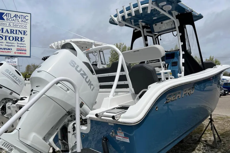 Slide: The Image of 2026 Sea Pro 225FLX Sandbar boat with Suzuki engines at a marine store. - 24