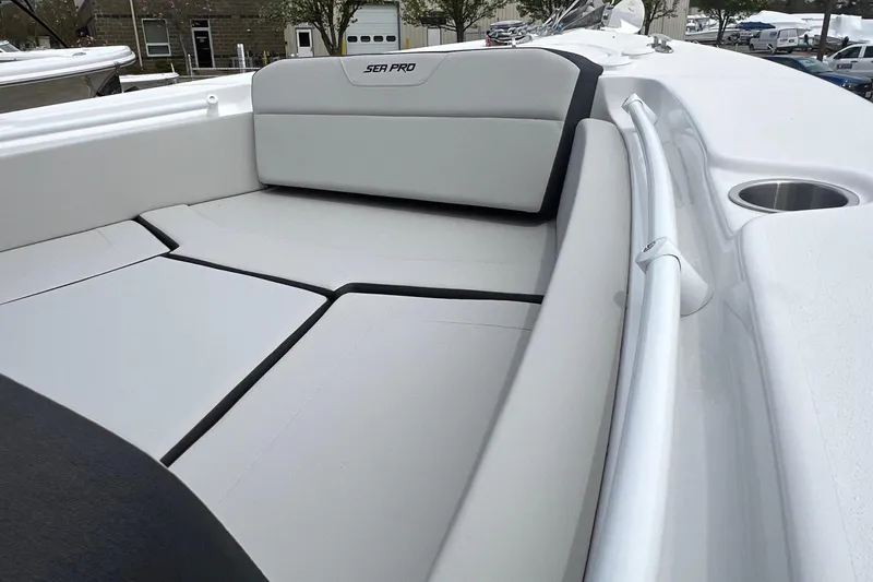 Slide: The Image of 2026 Sea Pro 225FLX Sandbar boat interior with cushioned seating and cup holder. - 6