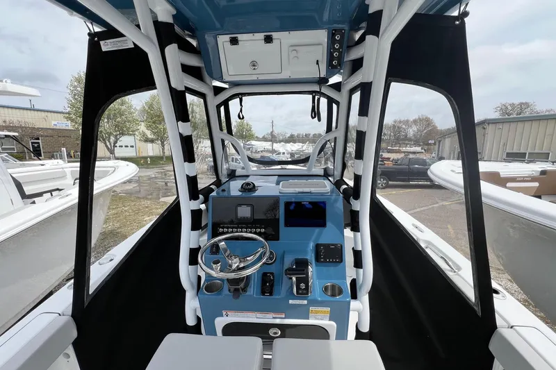 Slide: The Image of Interior view of 2026 Sea Pro 225FLX Sandbar boat cockpit with steering wheel and controls. - 7