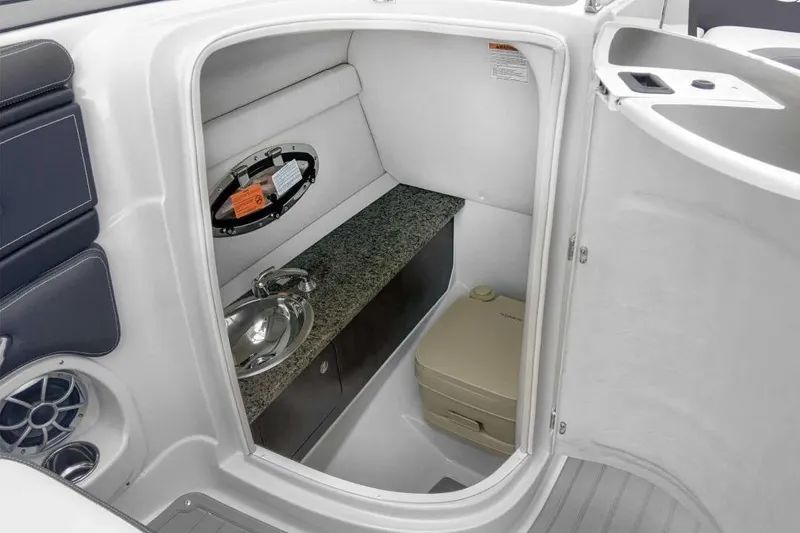 Slide: The Image of 2019 Crownline 255 SS SURF boat interior with sink and toilet. - 3