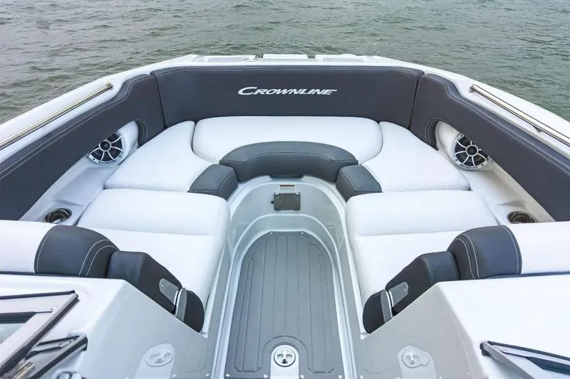 Slide: The Image of 2019 Crownline 255 SS SURF boat interior with white and gray seating, on water. - 7