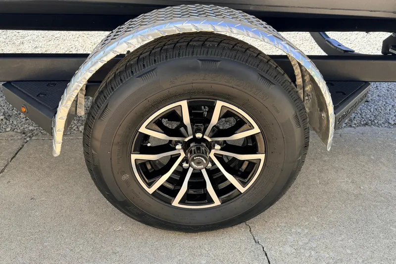 Slide: The Image of 2026 Crestliner 1650 Kodiak SC trailer wheel with black alloy rim and diamond plate fender. - 10
