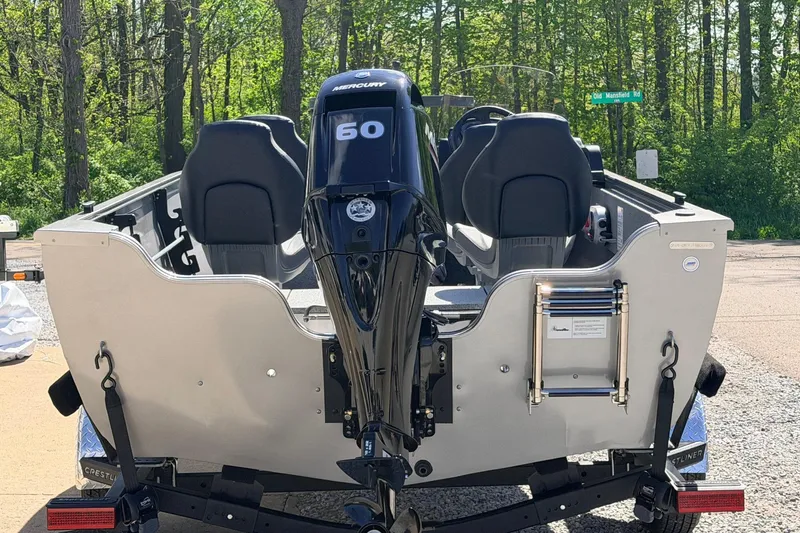 Slide: The Image of 2026 Crestliner 1650 Kodiak SC boat with Mercury 60 engine, parked outdoors. - 4