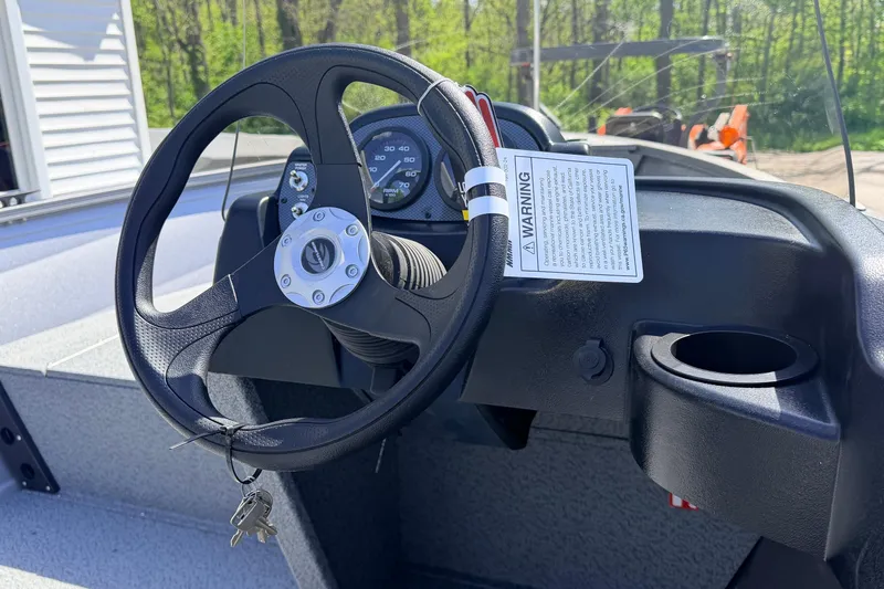 Slide: The Image of 2026 Crestliner 1650 Kodiak SC steering wheel and dashboard with warning label. - 5