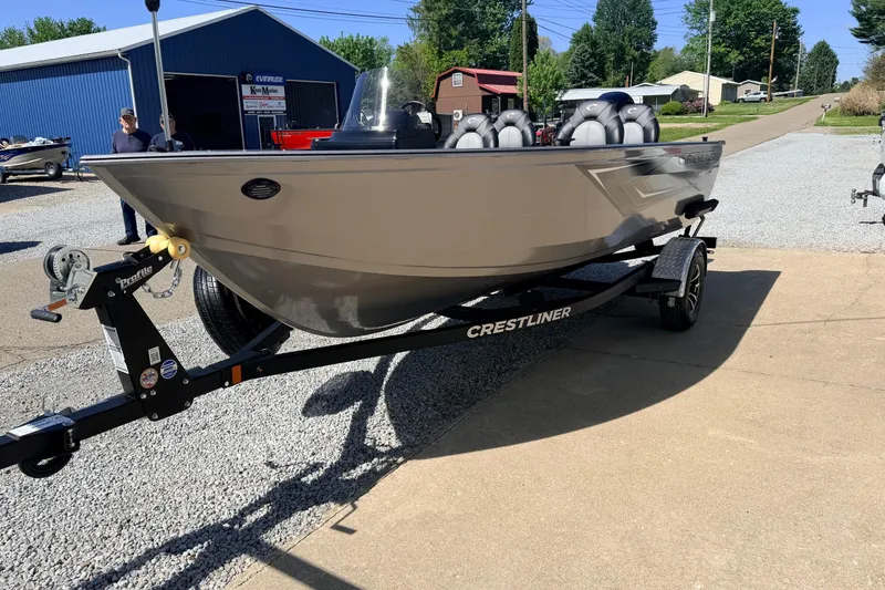 Slide: The Image of 2026 Crestliner 1650 Kodiak SC boat on trailer, parked outdoors in a sunny setting. - 8