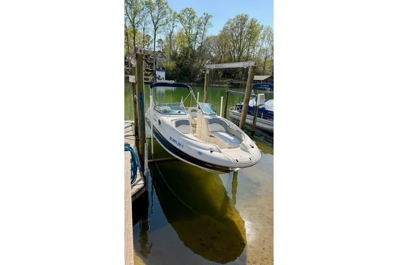 Slide: The Image of 2008 Sea Ray 240 Sundeck boat docked on a calm lake. - 3