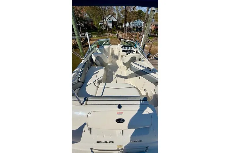 Slide: The Image of 2008 Sea Ray 240 Sundeck boat with spacious seating and sleek design. - 6
