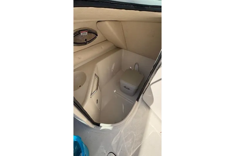 Slide: The Image of Interior view of 2008 Sea Ray 240 Sundeck boat's compact bathroom area. - 7