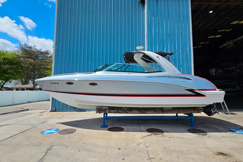 The Image of 2013 Formula 310 FX5 boat on display outside a blue warehouse. - 0