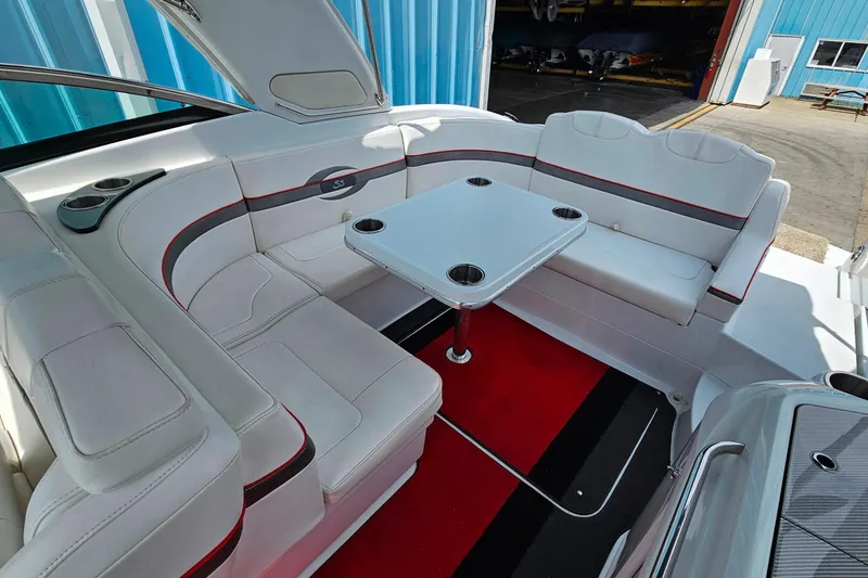 Slide: The Image of Luxurious seating area on a 2013 Formula 310 FX5 boat with a central table. - 10