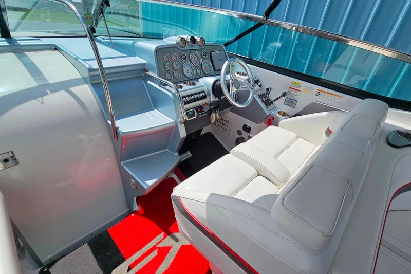 Slide: The Image of Interior of a 2013 Formula 310 FX5 boat with sleek dashboard and white seating. - 15
