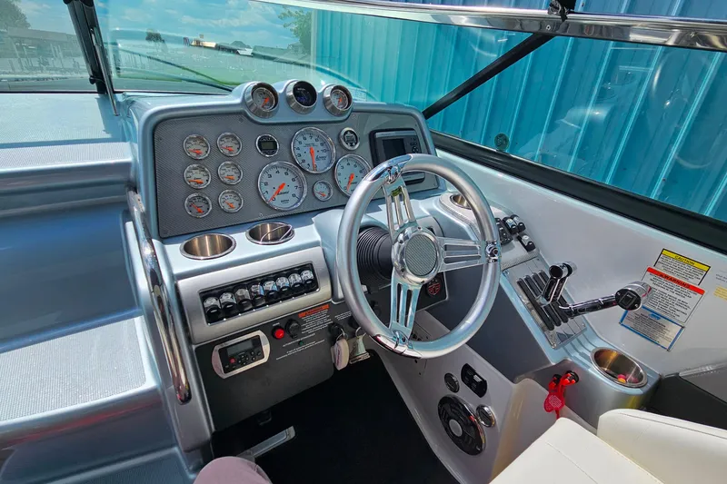 Slide: The Image of 2013 Formula 310 FX5 boat dashboard with gauges, steering wheel, and controls. - 17