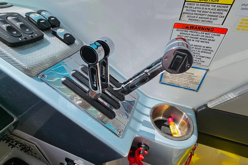 Slide: The Image of Control panel of a 2013 Formula 310 FX5 boat with throttle levers and warning labels. - 21