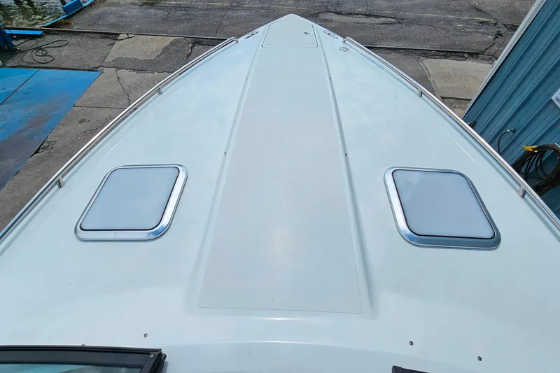 Slide: The Image of 2013 Formula 310 FX5 boat deck with dual hatches, docked at marina. - 22