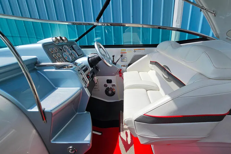 Slide: The Image of Interior of a 2013 Formula 310 FX5 boat with white seating and modern dashboard. - 23