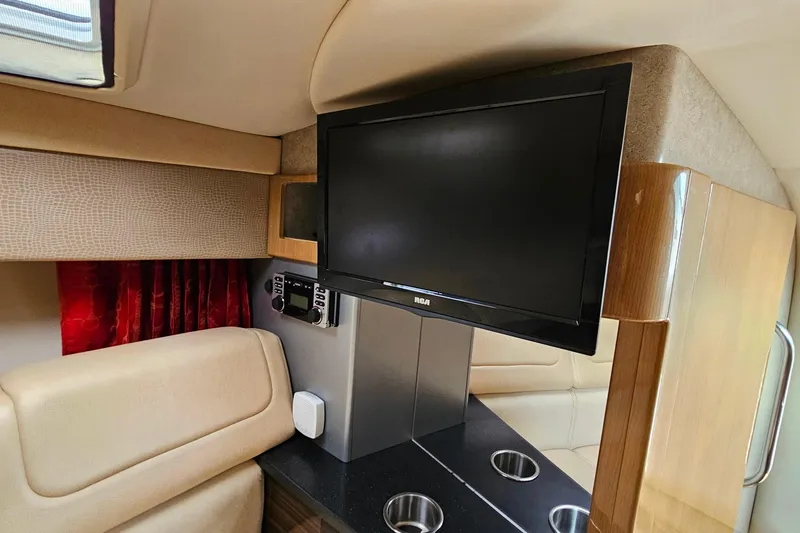 Slide: The Image of Interior of a 2013 Formula 310 FX5 boat with TV and seating area. - 27