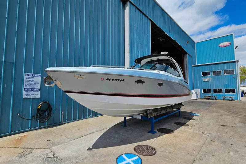 Slide: The Image of 2013 Formula 310 FX5 boat on display outside a blue warehouse. - 3