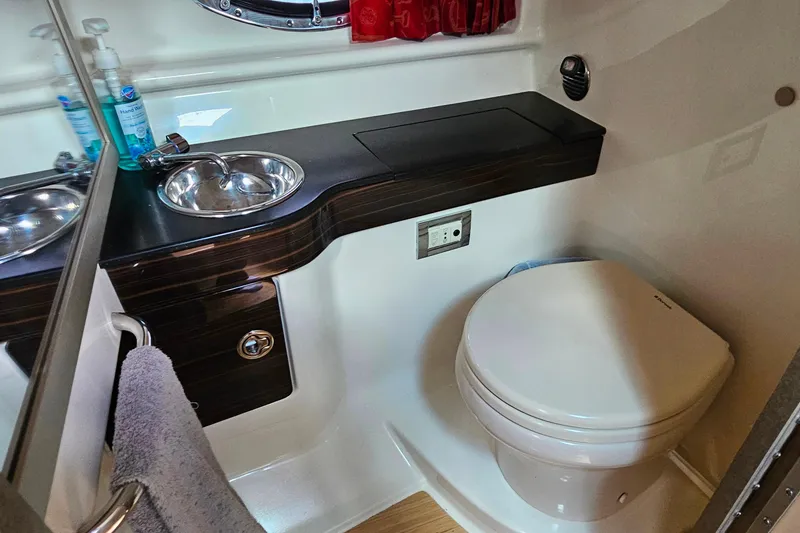 Slide: The Image of 2013 Formula 310 FX5 boat bathroom with sink, toilet, and countertop. - 30
