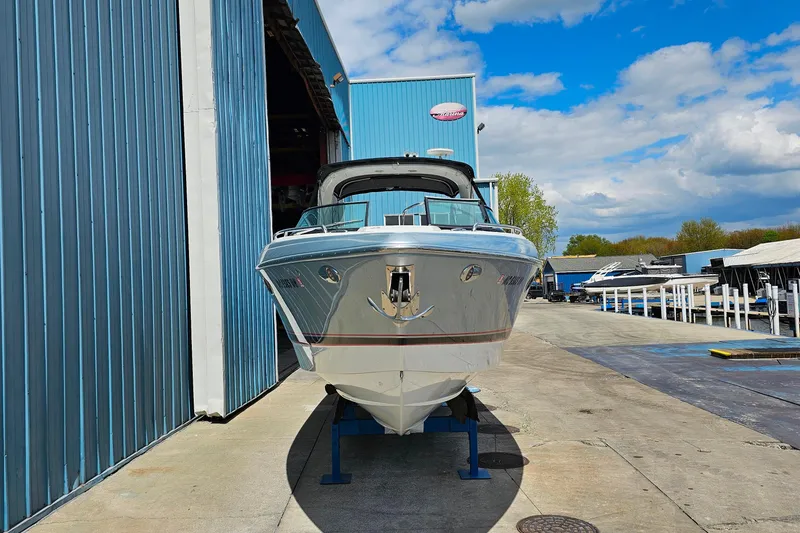 Slide: The Image of 2013 Formula 310 FX5 boat docked at a marina under a blue sky. - 4