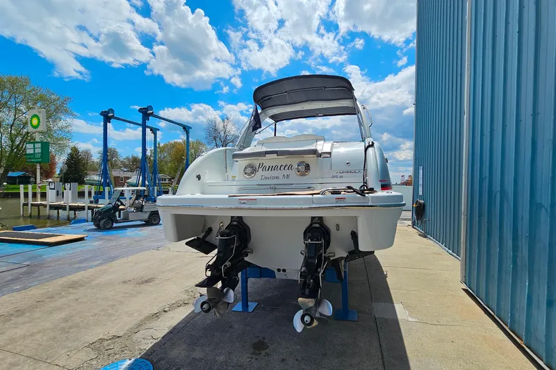 Slide: The Image of 2013 Formula 310 FX5 boat docked, showcasing dual propellers and sleek design under a blue sky. - 5