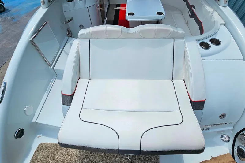 Slide: The Image of Luxurious seating on a 2013 Formula 310 FX5 boat, featuring sleek white upholstery. - 7