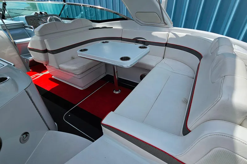 Slide: The Image of Interior of a 2013 Formula 310 FX5 boat with white seating and red accents. - 9