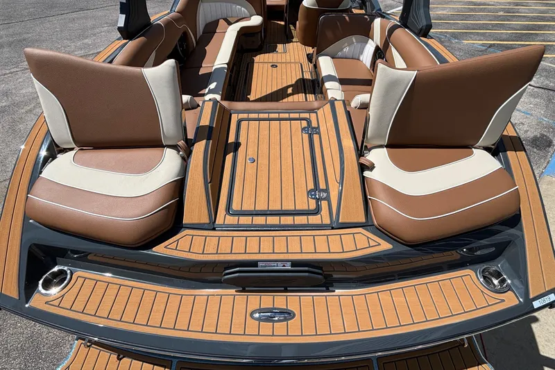 Slide: The Image of 2026 MB B52 23 Alpha boat interior with brown and cream seating, teak-style flooring. - 12