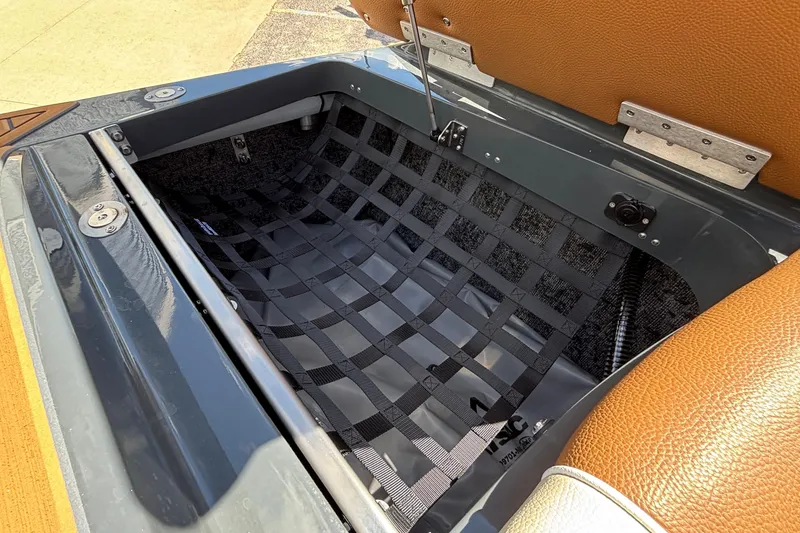 Slide: The Image of Open storage compartment in 2026 MB B52 23 Alpha boat with netting and leather trim. - 16