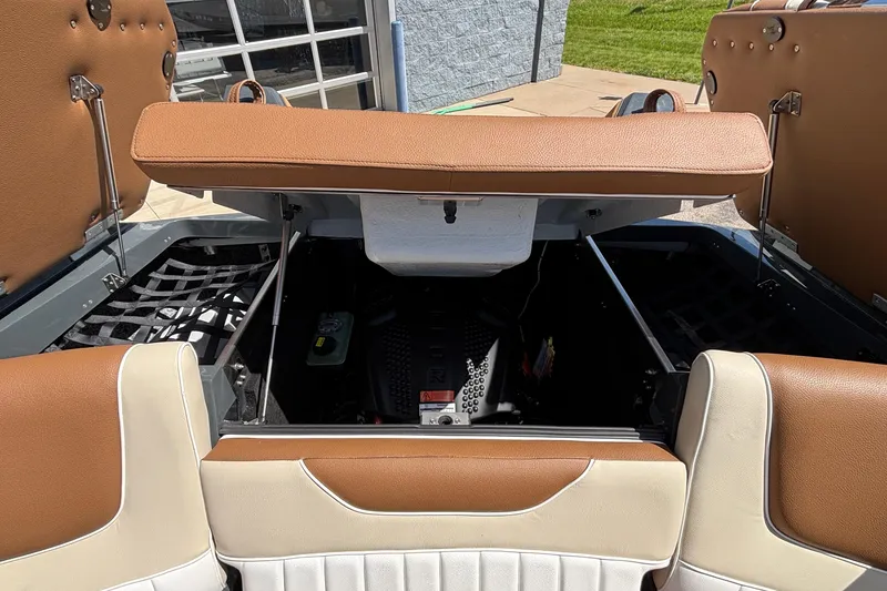 Slide: The Image of Open engine compartment of 2026 MB B52 23 Alpha boat with brown and white seating. - 17