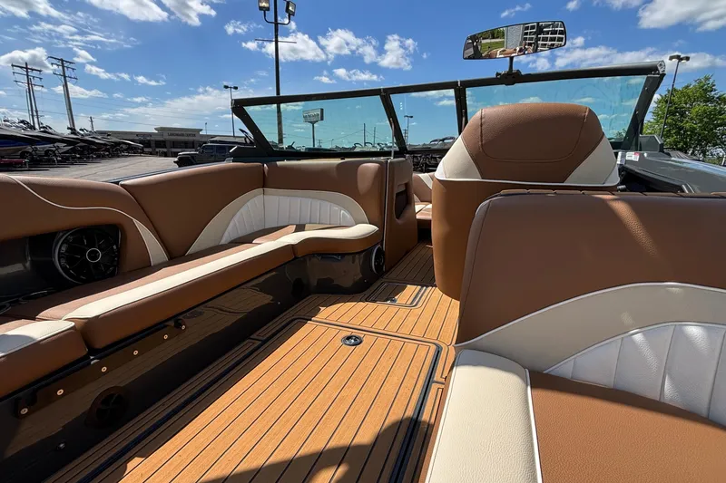 Slide: The Image of Interior of 2026 MB B52 23 Alpha boat with brown and white seating. - 23