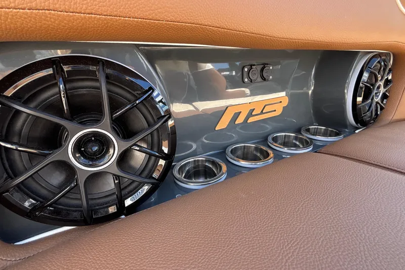 Slide: The Image of Interior of 2026 MB B52 23 Alpha with speakers and cup holders. - 29