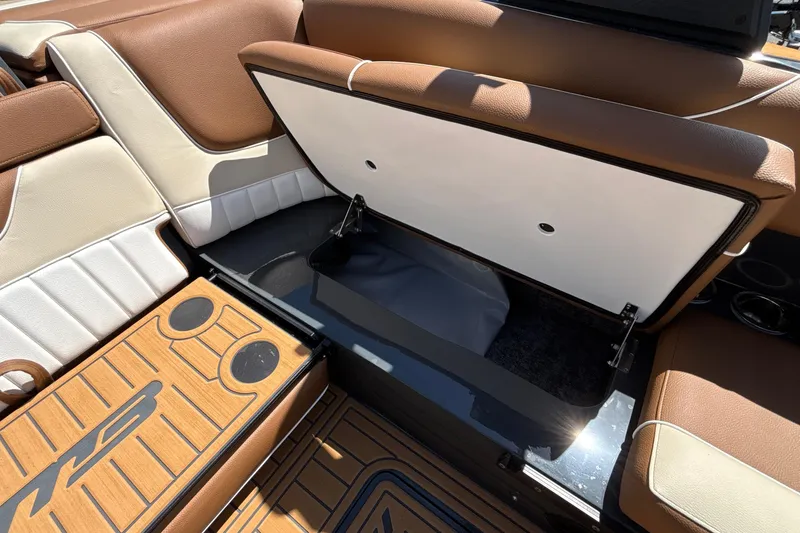 Slide: The Image of 2026 MB B52 23 Alpha boat interior with open storage compartment and brown seating. - 32