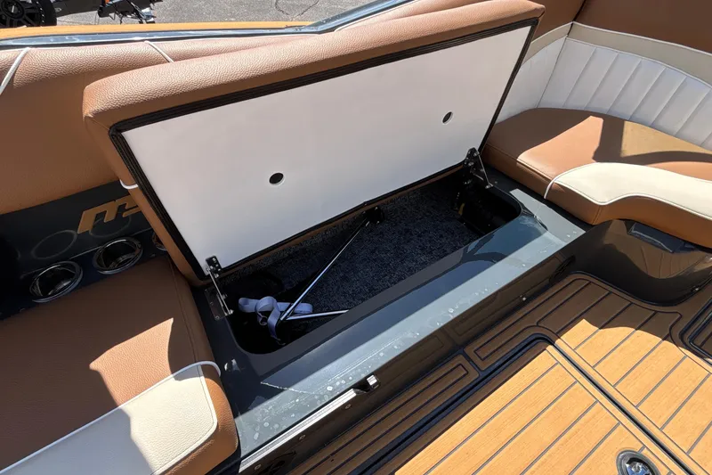 Slide: The Image of Open storage compartment in 2026 MB B52 23 Alpha boat with brown seating. - 33