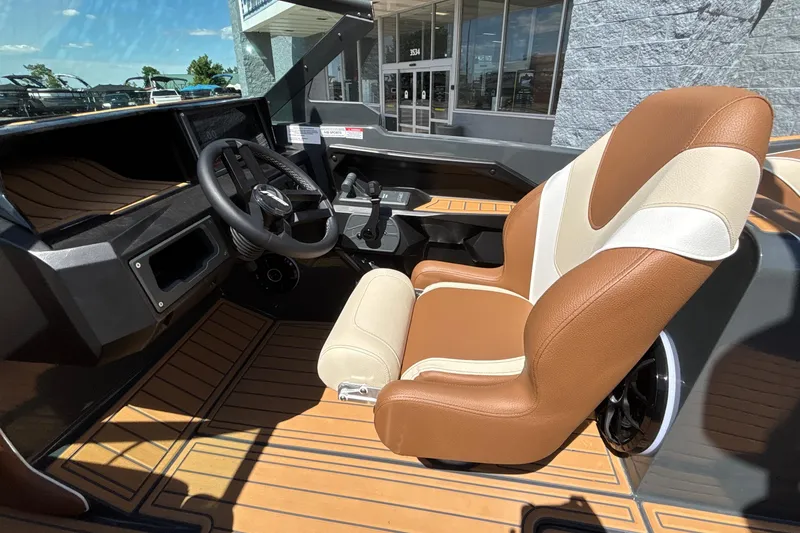 Slide: The Image of 2026 MB B52 23 Alpha boat interior with brown and cream seating, modern dashboard. - 37