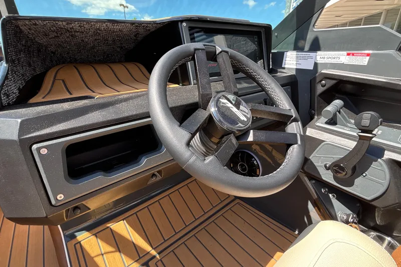 Slide: The Image of Steering wheel and dashboard of 2026 MB B52 23 Alpha boat, featuring modern controls. - 39